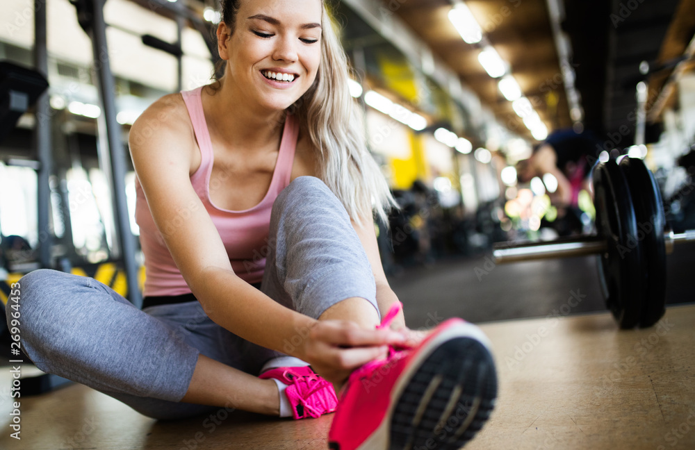 Fototapeta premium Fit sportswoman exercising and training at fitness club
