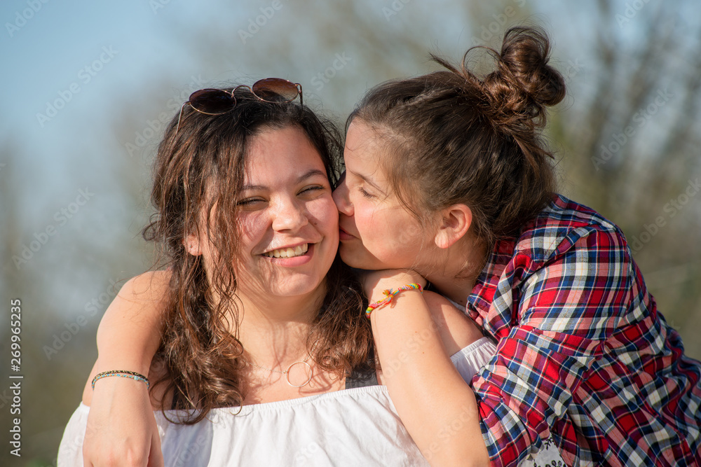portrait of two happy sisters, outdoors portrait of two happy sisters, outdoors