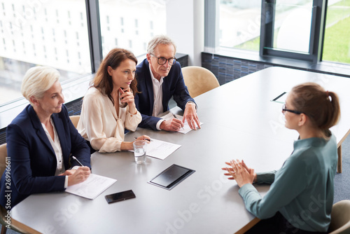 Woman during job interview and three elegant members of management photo