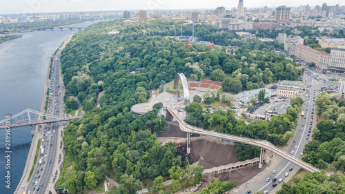 Aerial drone view of new pedestrian cycling park bridge construction, hills, parks and Kyiv cityscape from above, city of Kiev skyline, Ukraine © Iuliia Sokolovska