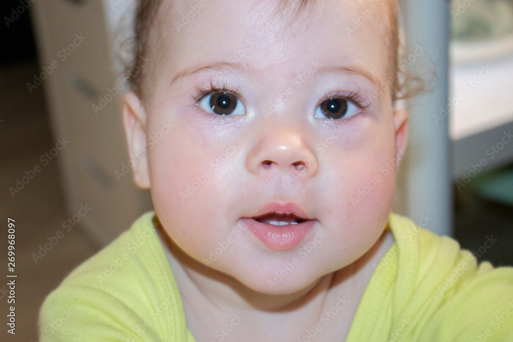Portrait of baby 8 month old girl boy curious caucasian, close-up face look into camera. Baby beautiful lips first teeth, very beautiful baby mouth Portrait of baby 8 month old girl boy curious caucasian, close-up face look into camera. Baby beautiful lips first teeth, very beautiful baby mouth