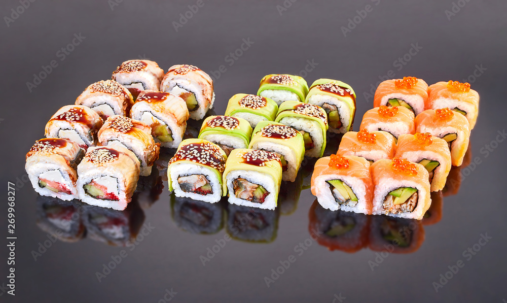 Various kinds of tasty sushi roll on black background for menu. Japanese food Various kinds of tasty sushi roll on black background for menu. Japanese food