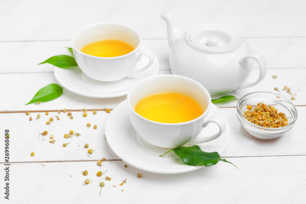 teapot and cups of tea on a white wooden background teapot and cups of tea on a white wooden background