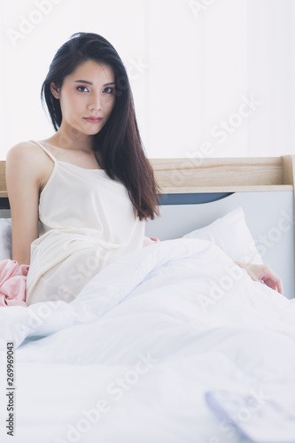  Asian woman model sitting and posing on bed.. © Bangkok Click Studio