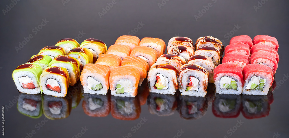 Various kinds of tasty sushi roll on black background for menu. Japanese food Various kinds of tasty sushi roll on black background for menu. Japanese food