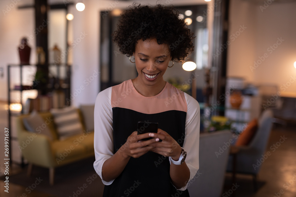 Businesswoman using mobile phone in office Businesswoman using mobile phone in office