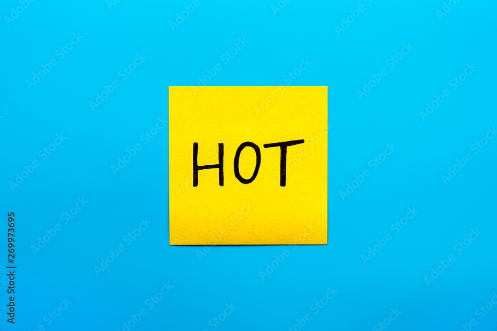 Seasons, summer, reminder and combination concept- Close up black handwritten inscription hot word on one yellow square sticker on blue background with copy spase, horizontal orientation Seasons, summer, reminder and combination concept- Close up black handwritten inscription hot word on one yellow square sticker on blue background with copy spase, horizontal orientation
