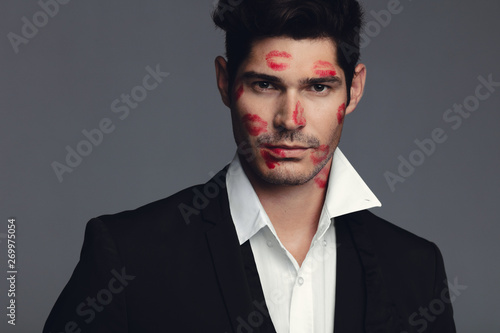 Konstfotografi Attractive man with lipstick marks on face