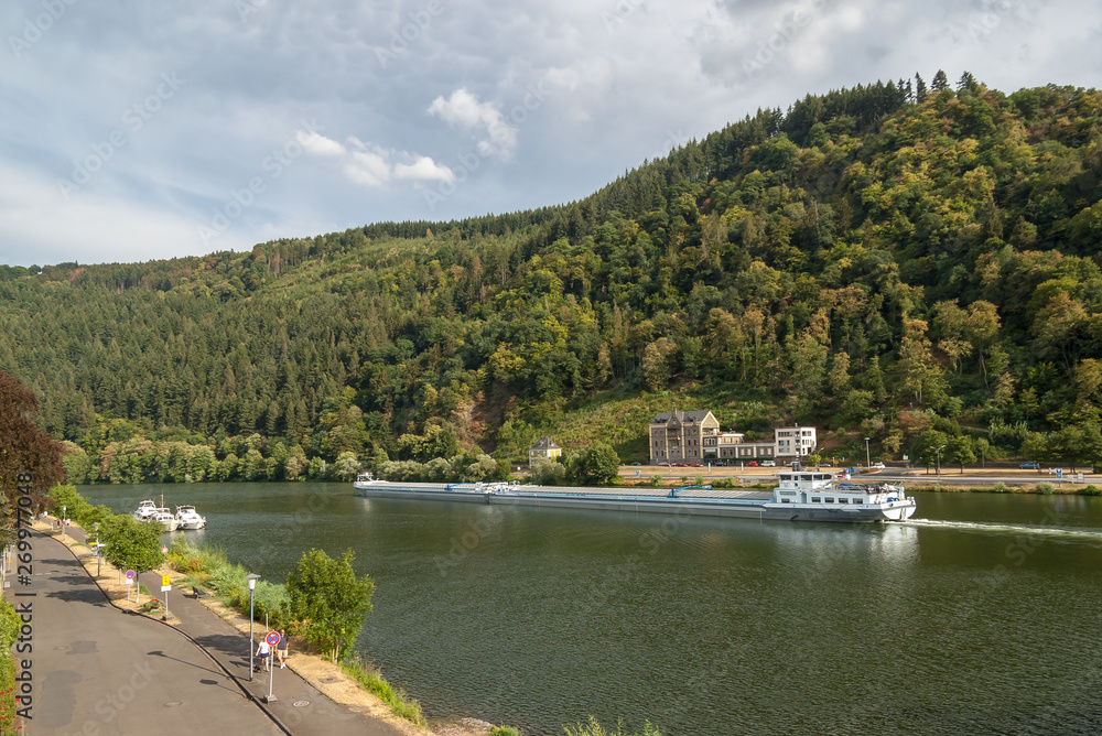 Ship freighter on Moselle river at the wine village of Traben-Trarbach, Rhineland-Palatinate, Germany, Europe.