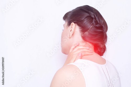 A young girl holds on to a sore neck in which the protrusion and fibromyalgia of the muscles, medical, copy space, vertebral instability photo