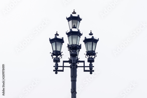 Old streetlight against the background of the sky. Close up.