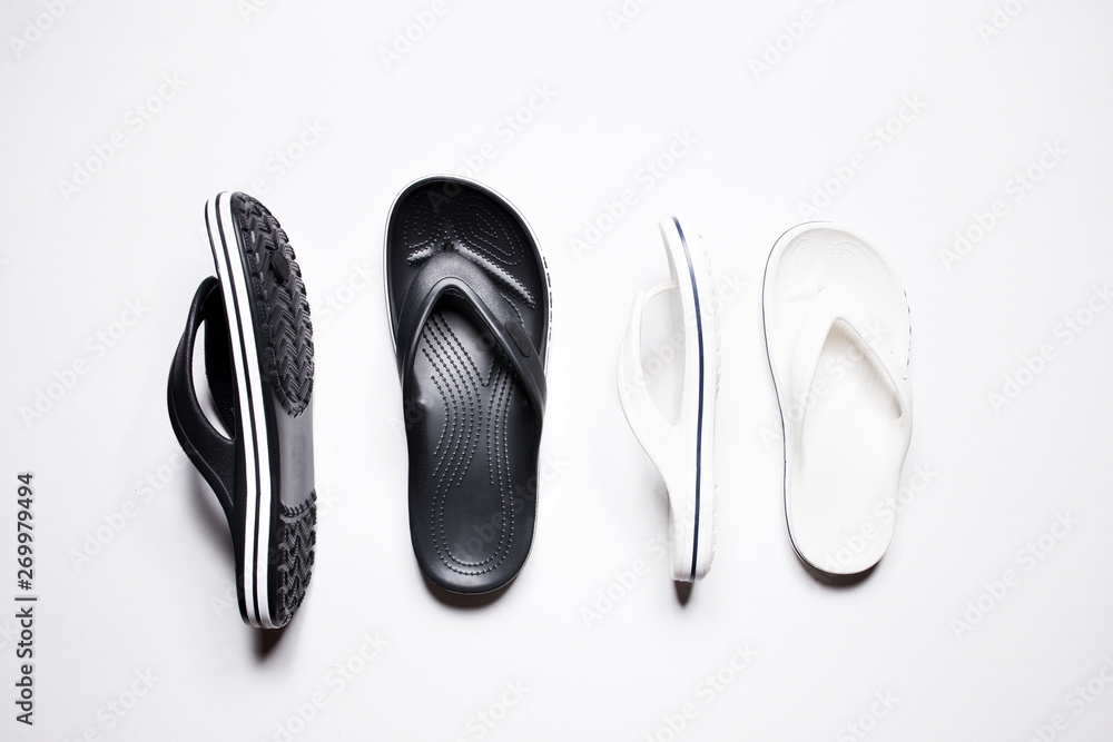 Flip Flops on a white isolated background. Black male and female white. Flip Flops on a white isolated background. Black male and female white.