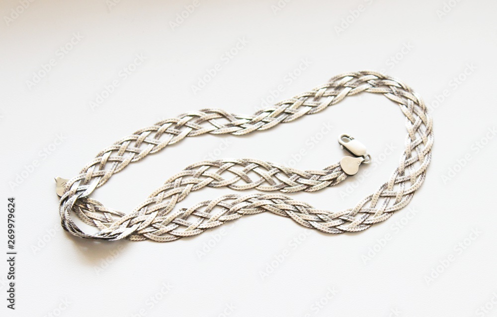 Silver chain located on a white background