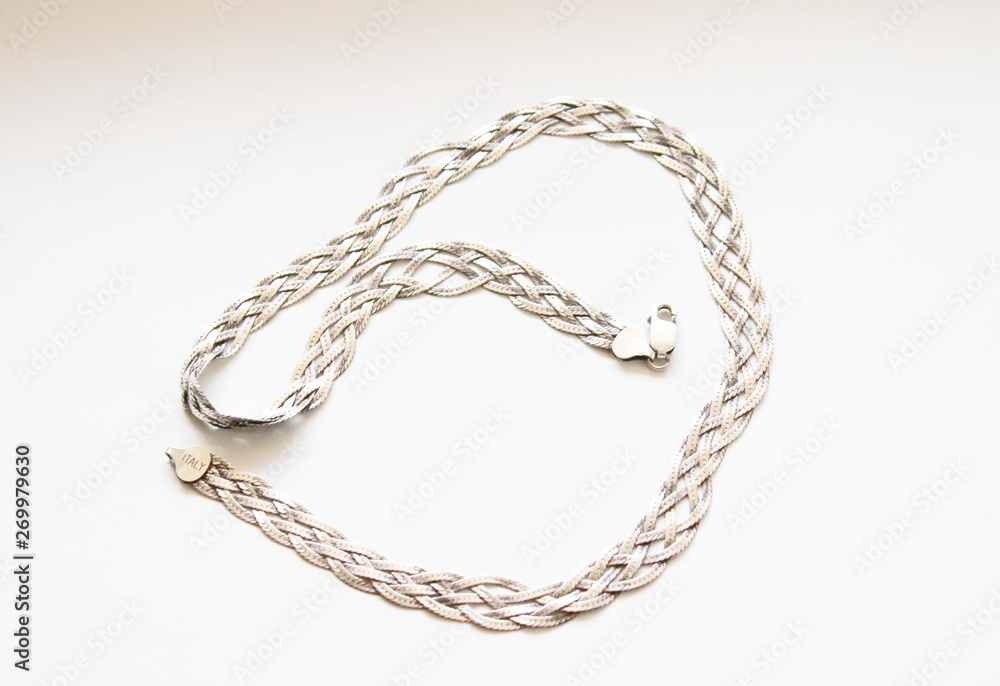 Silver chain located on a white background