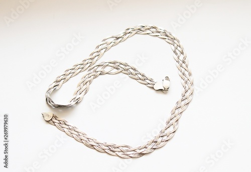 Silver chain located on a white background