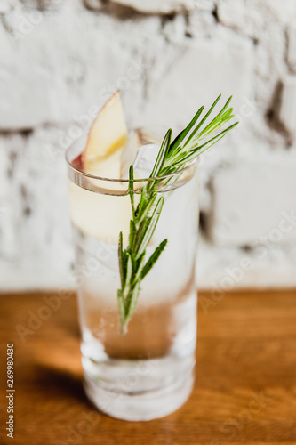 Wallpaper Mural A vertical image of a refreshing gin and tonic with rosemary and apple in a highball glass. Selective focus. Torontodigital.ca