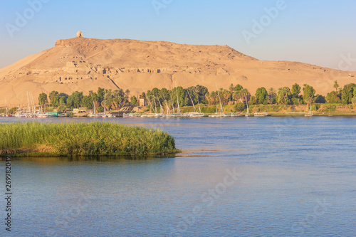 The Mausoleum of Aga Khan with feluccas on the Nile close to Aswan photo
