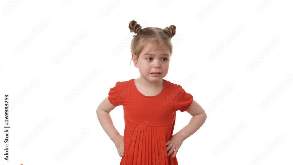 Video portrait of little girl crying in the red dress isolated on white background. Childhood concept. Studio video shot of child emotions in 4K definition. Video portrait of little girl crying in the red dress isolated on white background. Childhood concept. Studio video shot of child emotions in 4K definition.