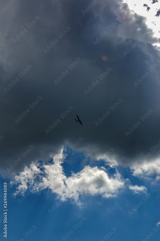 light aircraft against the sky with clouds