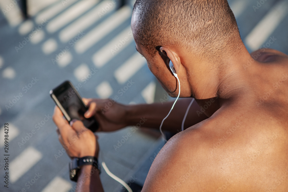 Man checking a playlist before training.