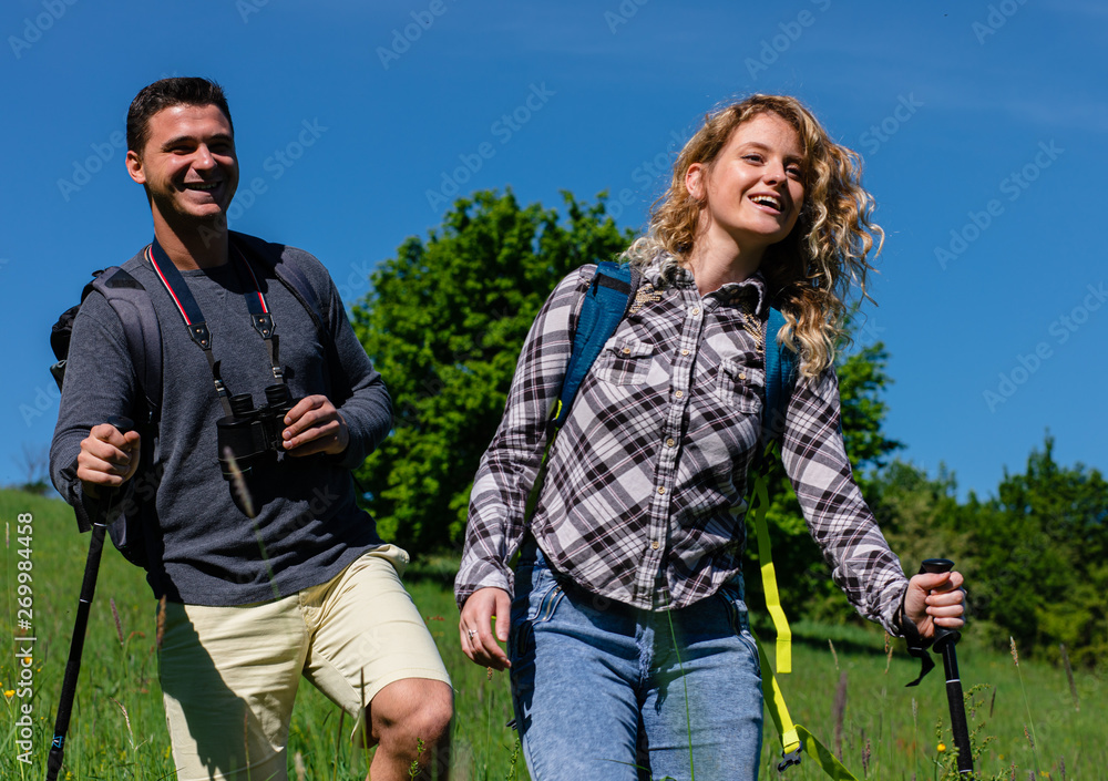 Young couple enjoying hiking together in nature.