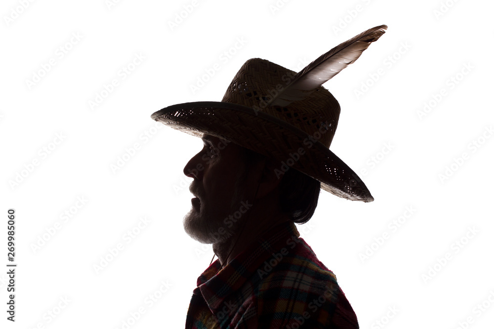 Old man in cowboy hat, side view - dark close-up silhouette Stock Photo