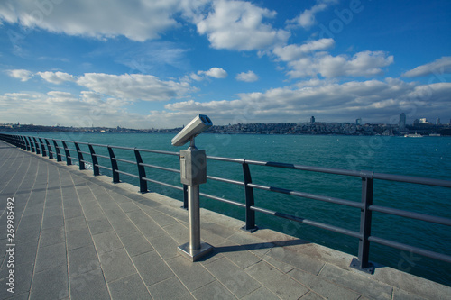 Travel concept. Tourist coin binocular at quay for promenade in Uskudar  the Bosphorus  Istanbul  Turkey. Sunny day. Blue cloudy sky. Outdoor shot