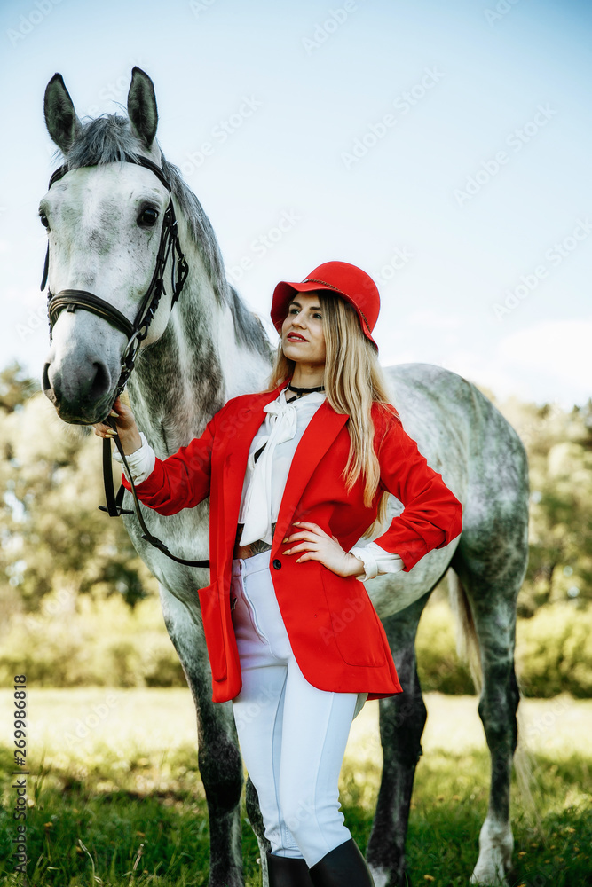 Obraz premium Beautiful young girl with blond hair in a suede jacket with a fringe , wearing black floppy hat