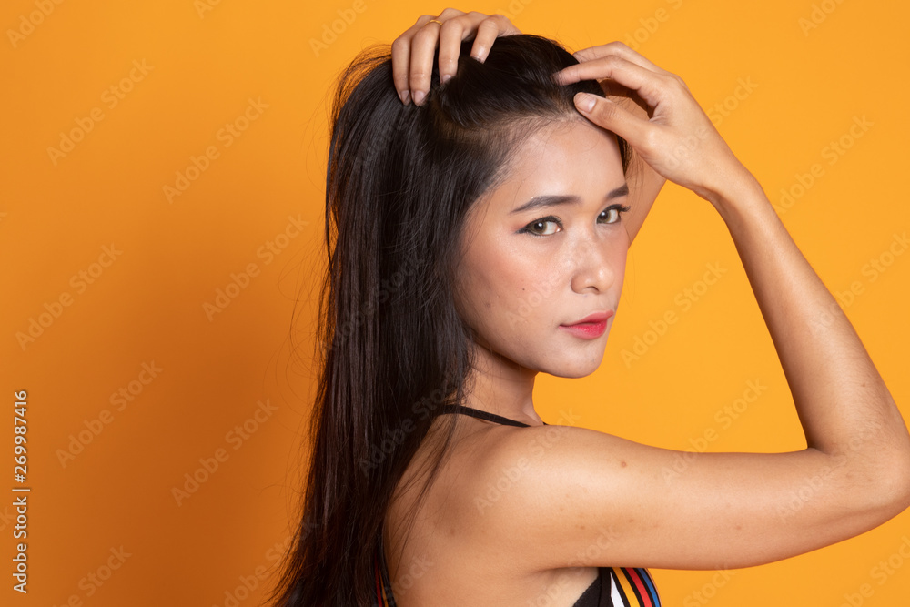 Fototapeta premium Portrait of beautiful young Asian woman in colorful shirt