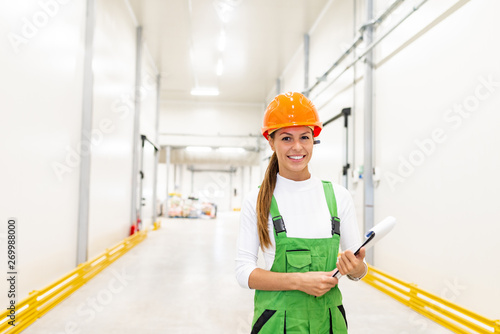Portrait of a smiling female food factory warehouse worker.