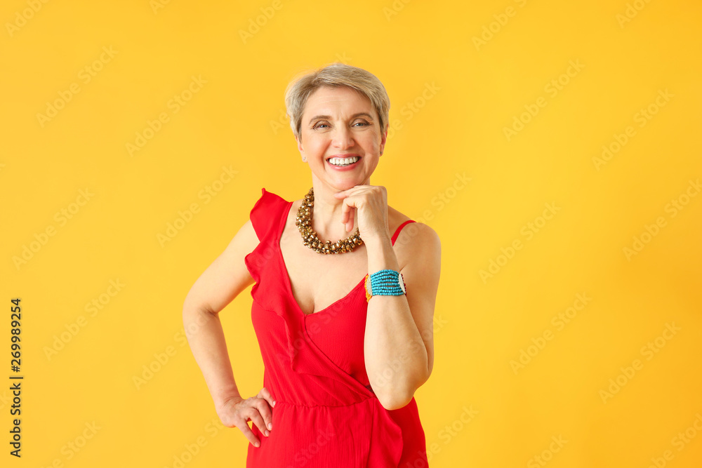 Fashionable mature woman on color background Fashionable mature woman on color background