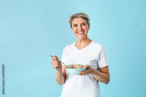 Mature woman with bowl of o...