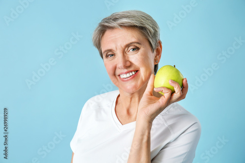 Mature woman with apple on ...