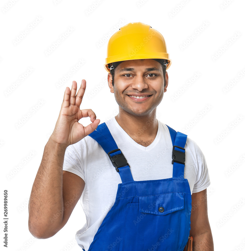 Handsome worker in hardhat showing OK on white background