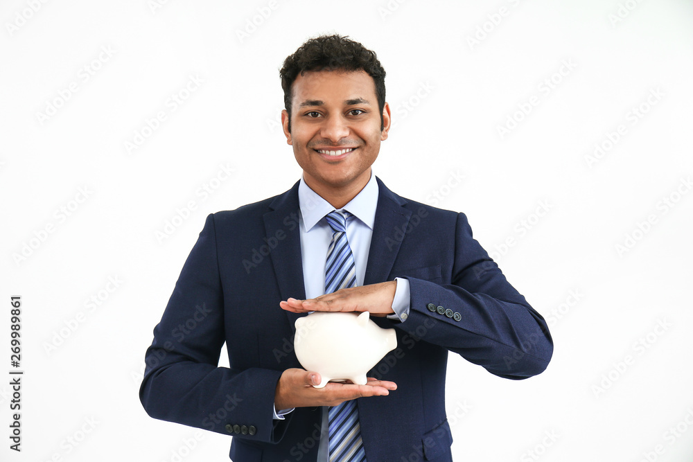 Handsome businessman with piggy bank on white background Handsome businessman with piggy bank on white background