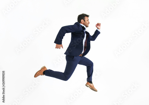 Running businessman against white background