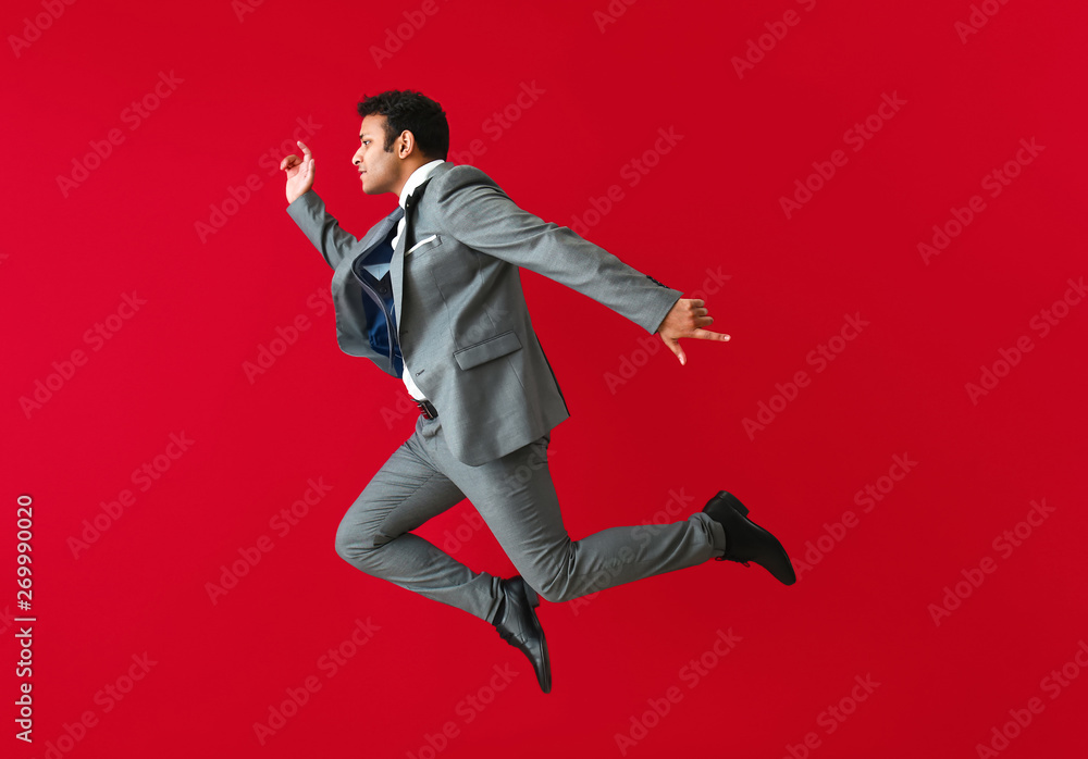 Jumping businessman on color background