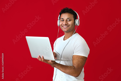 Handsome man with laptop an...