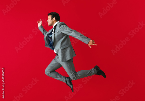 Jumping businessman on colo...