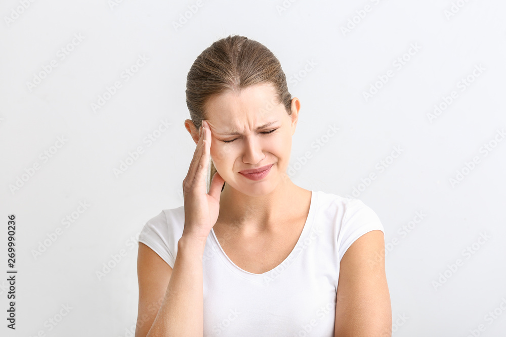 Young woman suffering from headache on white background Young woman suffering from headache on white background