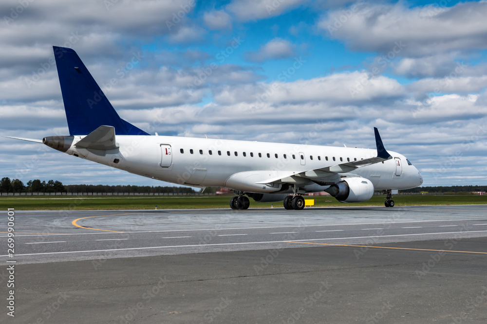 Taxiing a white passenger jet plane at the airport apron Taxiing a white passenger jet plane at the airport apron