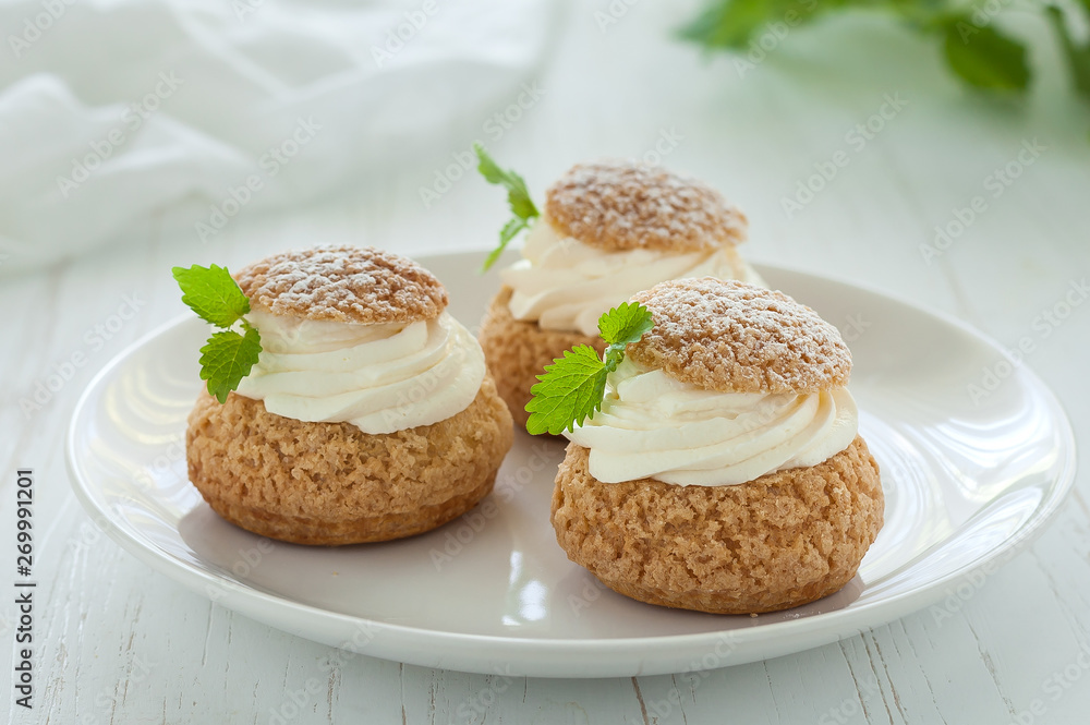 Choux Buns with Craquelin (crispy cream puffs) filled cream decorated Choux Buns with Craquelin (crispy cream puffs) filled cream decorated