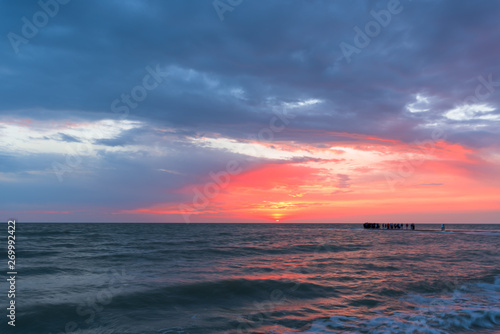 Sunset, moving clouds and sea waves on the beach . long exposure © Taranova_ksenya
