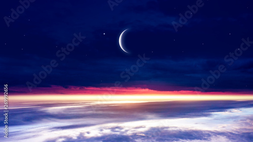 Crescent moon with beautiful sunset background . Generous Ramadan . Light from sky . Religion background .  