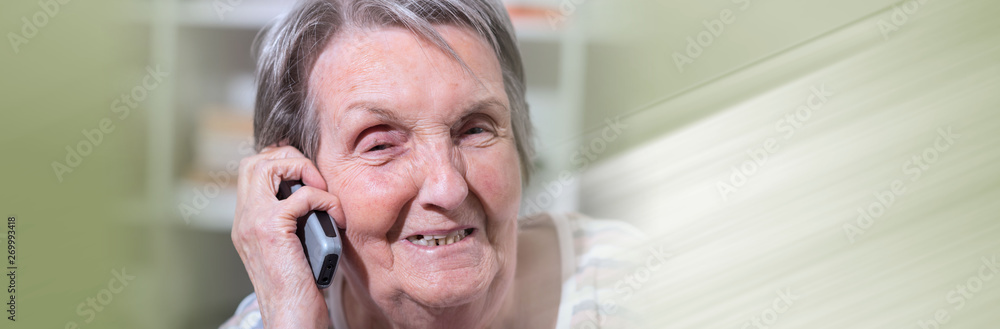 Elderly woman talking on the phone. panoramic banner Elderly woman talking on the phone. panoramic banner