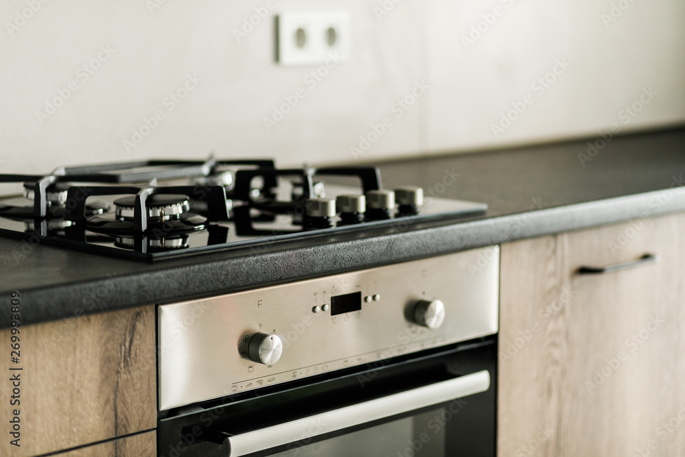 Stove closeup in modern kitchen interior with stainless steel gas cook-top.  Stock Photo