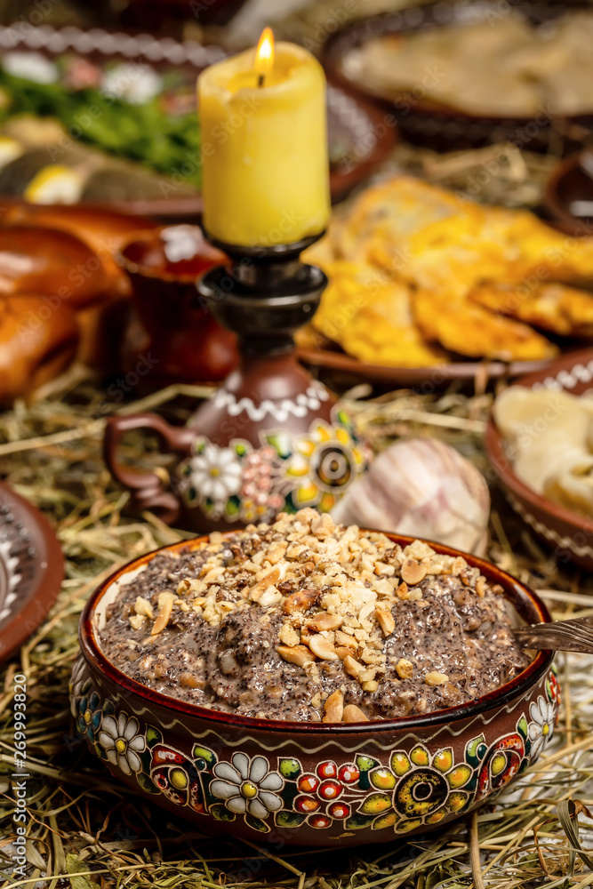 Bowl with kutia - traditional Christmas sweet meal in Ukraine, Belarus and Poland, on wooden table, Christmas Family Dinner Table Concep.