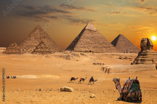 Beautiful sunset view on the Sphinx and the Pyramids of Giza  desert scenery with camels