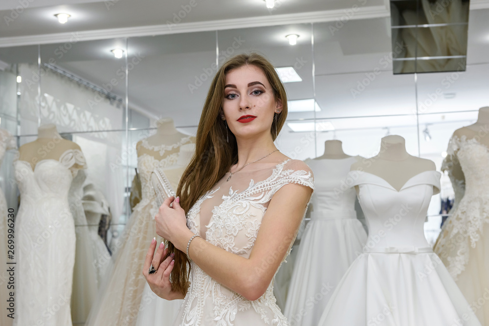 Attractive young bride in wedding dress in modern salon Attractive young bride in wedding dress in modern salon