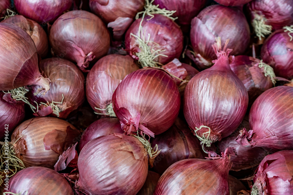 Vegetable background of many raw red onions. Red onions closeup. Vegetable background of many raw red onions. Red onions closeup.